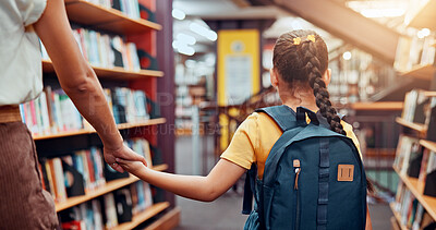 Buy stock photo Education, tutor and child in library, holding hands and walking with student, bookshelf and back. Knowledge, growth and development of kid with books, learning and teacher with girl in school
