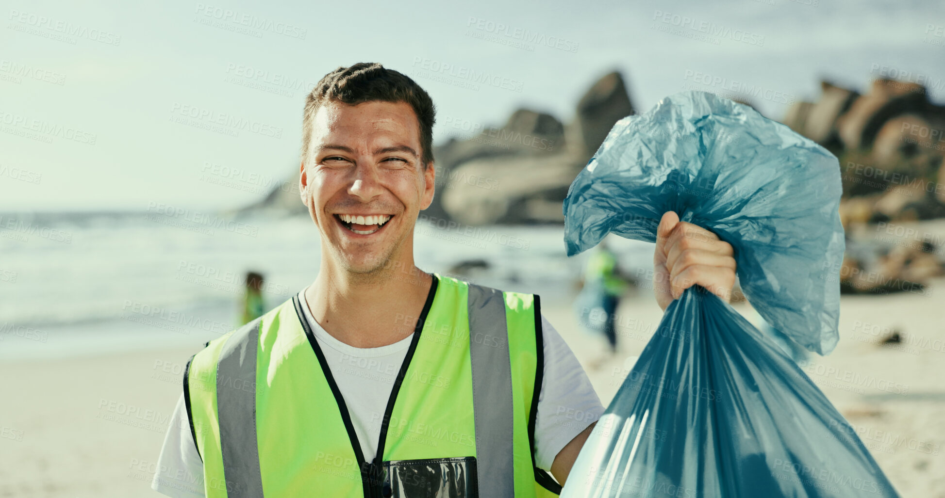 Buy stock photo Man, smile and plastic bag for cleaning beach in portrait, outdoor or excited on earth day with care for environment. Person, volunteer and happy by sea for accountability with trash, garbage or dirt