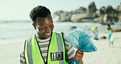Buy stock photo Happy man, volunteer and cleaning beach with bag for recycling, eco friendly environment or earth day. Male person, activist or community service with smile or dirt for save planet or world charity