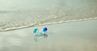 Buy stock photo Plastic bottle, beach and pollution in nature, water or outdoor on ground with dirt in environment. Container, trash and rubbish by waves, shore and sea with garbage for ecological crisis on earth