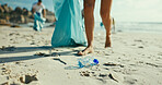People, volunteer and beach with plastic for recycling, eco friendly environment or earth day. Legs, activist or community service with charity workers for pollution, litter or cleaning ocean coast