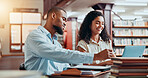 University, books and students in library on laptop for online research, information and studying for project. College, academy and man and woman on computer for education, knowledge and learning