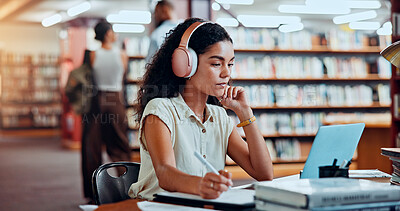 Buy stock photo Student, headphones and laptop in library for university, woman and studying for education or project. Female person, notes and academy campus with online video, research and assignment for knowledge