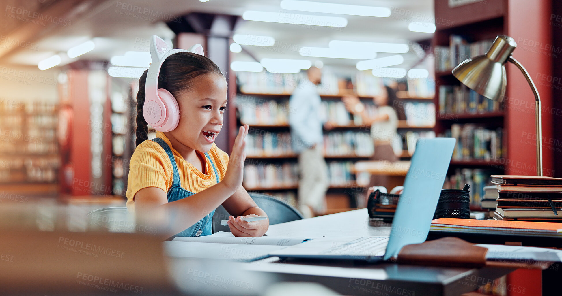 Buy stock photo Child, girl and laptop for video call in library, online education class or elearning with wave for academic development. Student, kid and virtual school with hello, headphones and learn for growth