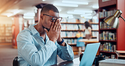 Buy stock photo Black man, laptop and stress in library for education, research or project deadline for university student. African person, glasses and headache with eye strain on campus for overtime or burnout
