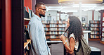 Couple, talking or man with woman in library for dating, college education and chat on break. University, interracial and students flirting in campus for learning, relationship and studying together