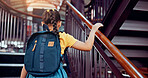 Walking, stairs and back of child in library for reading story, literature and learning at school. Academy, young student and girl with backpack for knowledge, education and language development