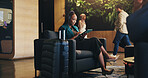 Business woman, headphones and tablet in lobby for planning, research or travel for seminar. Chair, music or streaming with happy flight passenger in hotel with luggage or suitcase for job trip