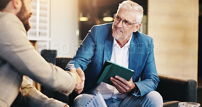 Buy stock photo Business people, mature or CEO shaking hands for negotiation, agreement or b2b deal in lobby. Tablet, executive director or entrepreneur greeting investor for handshake offer, partnership or meeting