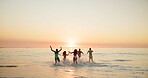 Beach, travel and friends with vacation, sunset and bonding together with tropical island. People, ocean and group with summer holiday, running and splash water with energy, happiness and Zanzibar