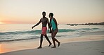 Happy, black couple and laugh for walk on beach of summer vacation, tropical journey and romantic date. Smile, people and holding hands for ocean travel, commitment and funny joke for getaway holiday