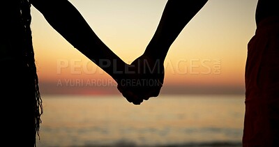 Buy stock photo Love, silhouette and holding hands with couple at beach for romance, connection or honeymoon vacation. Support, trust and sunset date with closeup of people in nature for bonding, commitment and trip