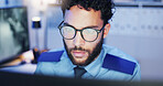 Watching, footage and security guard with computer, man and monitoring of danger, night or safety. Serious, law enforcement and person with glasses in control room, protection or tech for observation