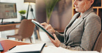 Woman, scroll and tablet in office for business, legal research and communication. Mature lawyer, technology and typing in law firm for case study, planning agenda and reading article for information