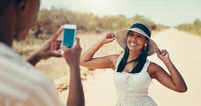 Buy stock photo Hat, travel and picture of couple with phone for holiday memory, fashion or smile on journey. Man, woman and mobile for photograph outdoor in desert on safari adventure, trip or post on social media