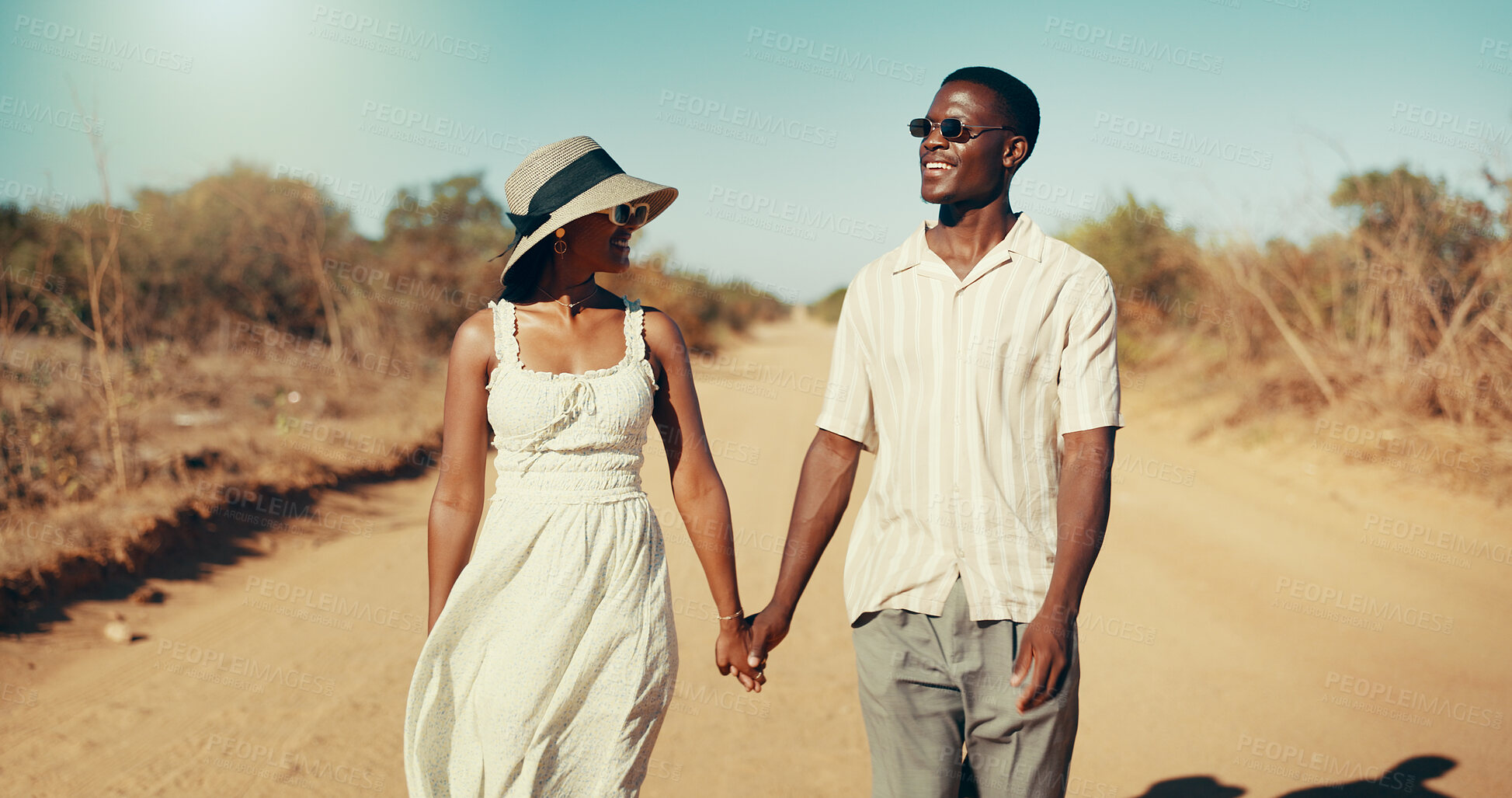 Buy stock photo Couple, happy and holding hands on safari, path and connection with love for romance on holiday in summer. African man, woman and smile on dirt road, bonding and anniversary on vacation in Kenya