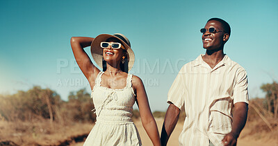 Buy stock photo Smile, couple and holding hands for safari travel with love, summer holiday and romantic adventure. Happy, people and sunglasses for wilderness vacation, commitment and explore desert for Africa trip