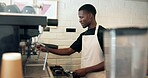 Barista, machine and man with grind preparation in cafe for latte order, premium caffeine and brewing process. Restaurant, black person and making coffee for espresso drink, customer service or mocha