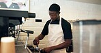 Barista, machine and man with grind tool in cafe for coffee preparation, premium caffeine blend and brewing process. Restaurant, black person and espresso drink order for customer service and latte
