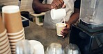 Barista, hands and milk in coffee for art, heart shape and creative beverage preparation in cafe. Person, drink and pour foam in latte for morning brew, cappuccino and dairy cream in small business