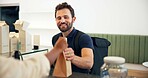 Happy man, courier or serving with delivery at cafe counter for parce, online order or purchase. Male person, ecommerce or smile with package or paper bag for transportation service at coffee shop