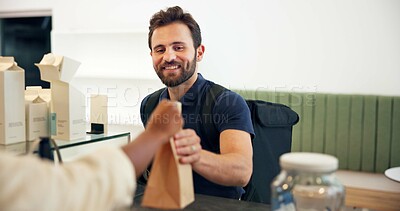 Buy stock photo Happy man, courier or serving with delivery at cafe counter for parce, online order or purchase. Male person, ecommerce or smile with package or paper bag for transportation service at coffee shop