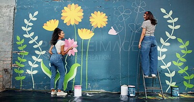 Buy stock photo Women, talking or friends painting on wall for mural, drawing flowers or community service at building. Artist, creative or girls with teamwork for floral decoration, renovation or project for design