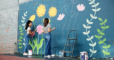 Buy stock photo Girls, painters or teamwork for wall for mural, drawing flowers or community service at building. Artist, talking or creative women with craft for floral decoration, renovation or project for design