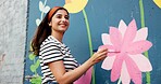 Thinking, creative or happy woman with wall for mural, drawing flowers or community service at building. Artist, craft ideas or girl with color for floral decoration, renovation or project for design