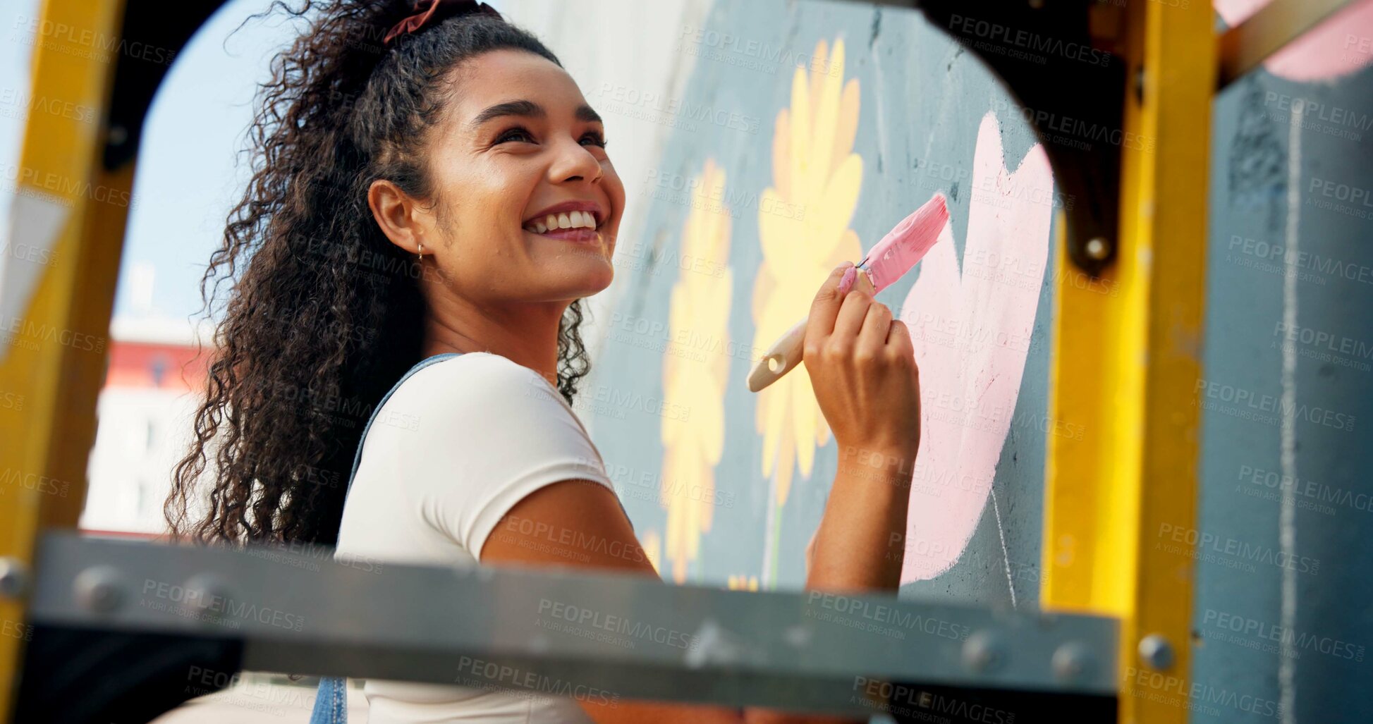 Buy stock photo Happy, mural and woman painting wall for art design, creative project and community service. Artist, volunteer and person with paintbrush outdoor for flower decor, inspiration and DIY hobby in city