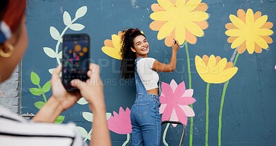 Buy stock photo Mural, wall and picture of woman, outdoor and phone screen with art, flowers and decor for painting. Photography, painter and creative for community project, social media and people with mobile app
