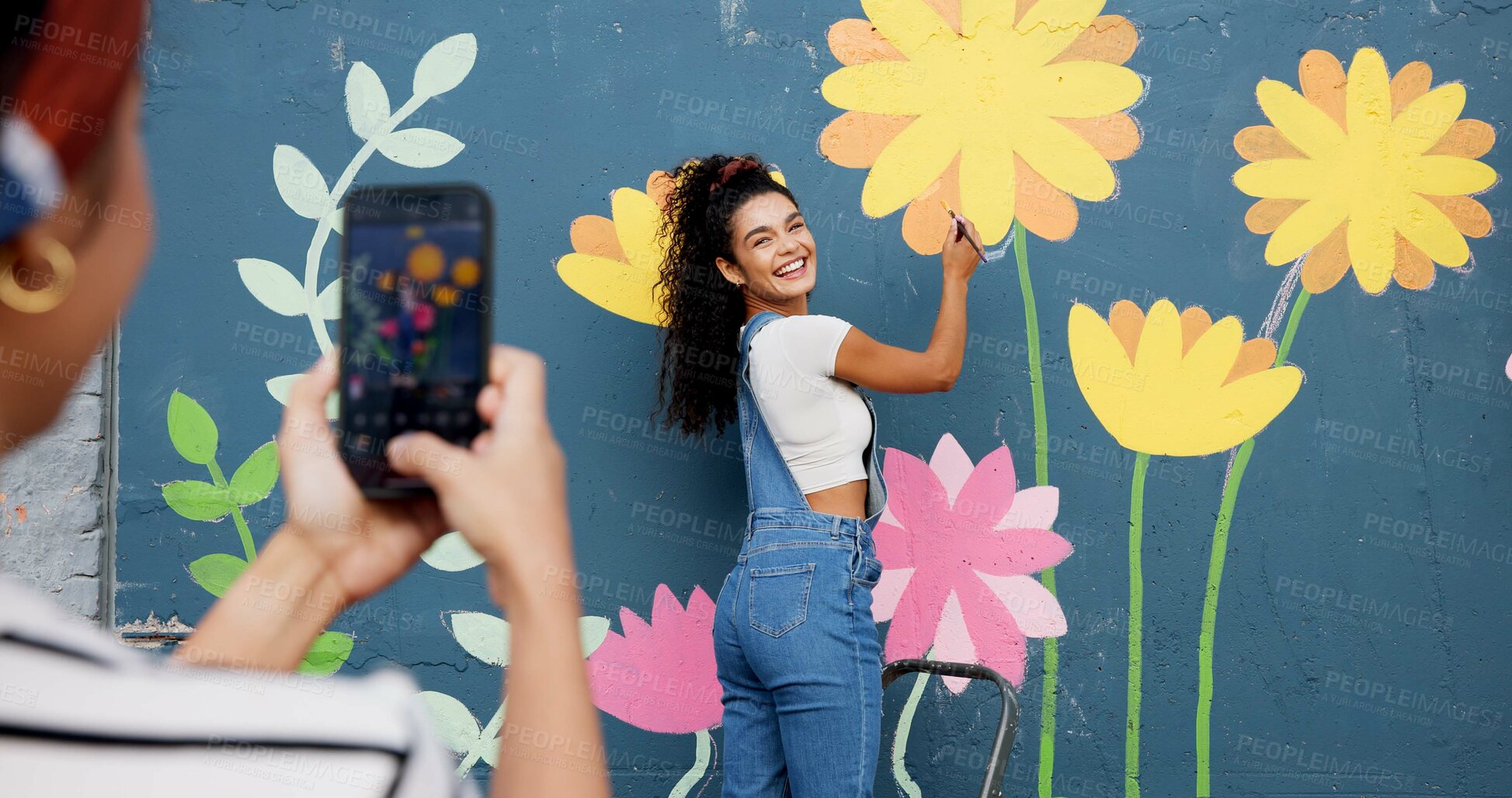 Buy stock photo Mural, wall and picture of woman, outdoor and phone screen with art, flowers and decor for painting. Photography, painter and creative for community project, social media and people with mobile app