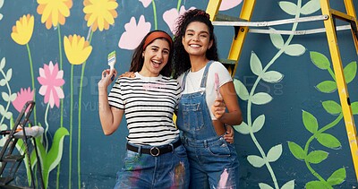 Buy stock photo Wall art, creative and women with paintbrush, outdoor and proud of decoration, mural and laughing. Confident, painter and people with design in neighbourhood, portrait and community project in Canada