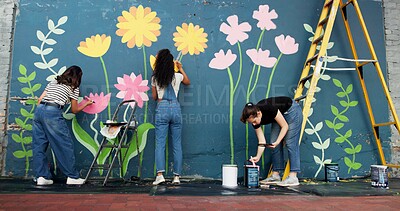 Buy stock photo Artist, women and painting mural on wall for sustainable awareness, environmental activism or creative project. Flower art, back or volunteer group with floral decor for earth day design and teamwork