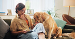 Home, treat and woman with dog on sofa for bonding, relax and chill together in living room. Best friend, pet and person with Golden Retriever on couch for animal care, love and fun on weekend