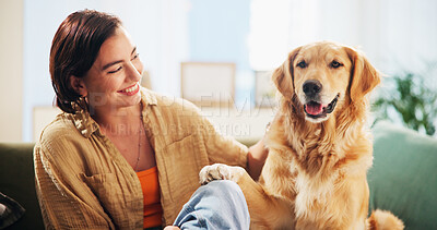 Buy stock photo Dog, woman and play with paw on sofa in home, relax and care with bonding, happy and trust in living room. Person, pet and golden retriever with touch, training and loyalty with love at apartment
