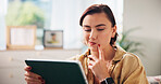 Woman, tablet and thinking on sofa, search and streaming with video in living room at apartment. Girl, person and digital touchscreen with app, film subscription and choice for movie on couch in home