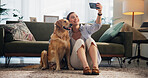 Home, selfie and woman on floor, dog and bonding together with happiness in living room. Person, apartment and pet owner with mobile user, profile picture and relax with smile, photography and memory