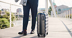 Business person, legs and walking with suitcase on bridge for commute, career travel or job opportunity. Employee, tourist or traveler with luggage or trip for new destination, immigration or journey