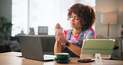 Buy stock photo Woman, home and wrist pain with laptop or tablet for discomfort, stress or overworked strain. Female person, freelancer or remote worker with carpal tunnel syndrome or joint inflammation at house