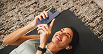 Woman, smartphone and earphones with fitness break in house, listen to music or social media comment response. Audio tech, app or exercise blog with review, post for communication or workout chat