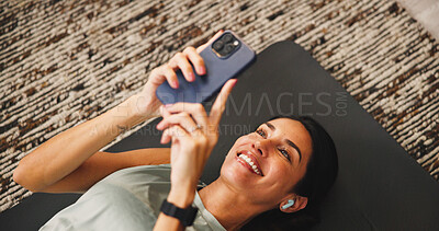 Buy stock photo Woman, smartphone or earphones with fitness break in home, listen to music or social media comment response. Audio tech, above or exercise blog with review, app post for communication or workout chat