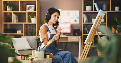 Buy stock photo Music, painting and wrist pain with woman in living room of home for artistic or creative hobby. Arthritis, carpal tunnel or cramp and mature painter in apartment with canvas on easel for expression