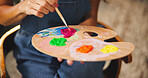 Person, hands and artist with paint palette for colorful art, design or creativity at home. Closeup, painter or designer with brush, tray or color mix for drawing skill, blending talent or artwork
