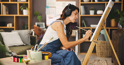 Buy stock photo Artist, woman and painting with headphones at house for listening to music, podcast audio and art project. Female person, brush and streaming sound with canvas for artwork, creative process and craft