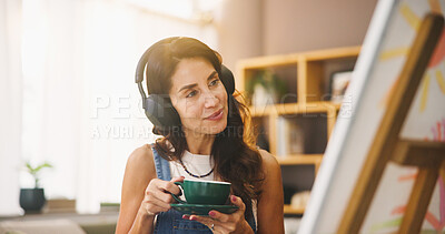 Buy stock photo Woman, artist and coffee with headphones for painting, listening to music and art project. Person, beverage and streaming sound with canvas for artwork progress, creative process and craft at house