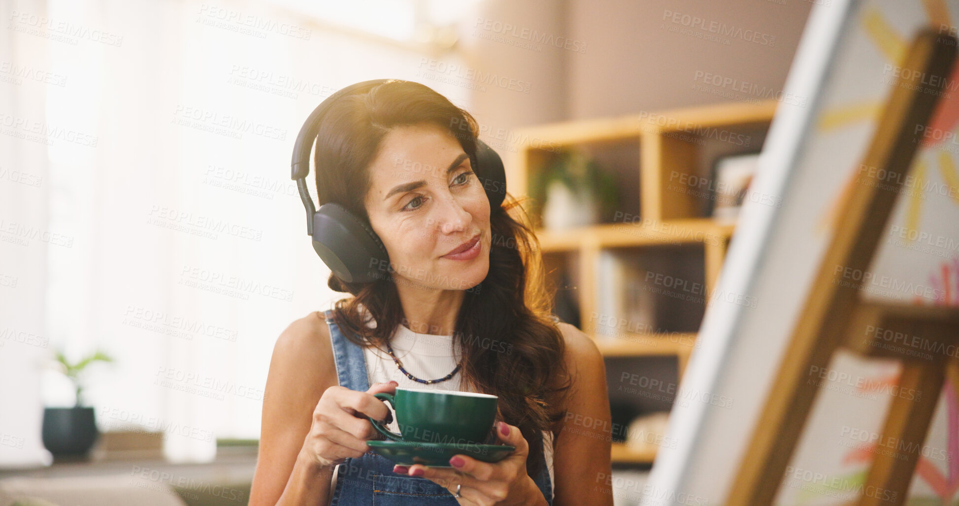 Buy stock photo Woman, artist and coffee with headphones for painting, listening to music and art project. Person, beverage and streaming sound with canvas for artwork progress, creative process and craft at house