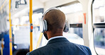 Bus, travel and man with headphones, music and commuting to work in morning, listening or audio. Back, employee and person with tech for playlist, sound and passenger with radio for trip or streaming