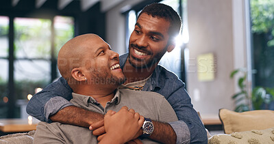 Buy stock photo Home, hug and gay couple with laugh, smile and happy with relationship and romance or support. Couch, apartment and queer people with lgbtq, embrace and marriage for commitment or emotion with love