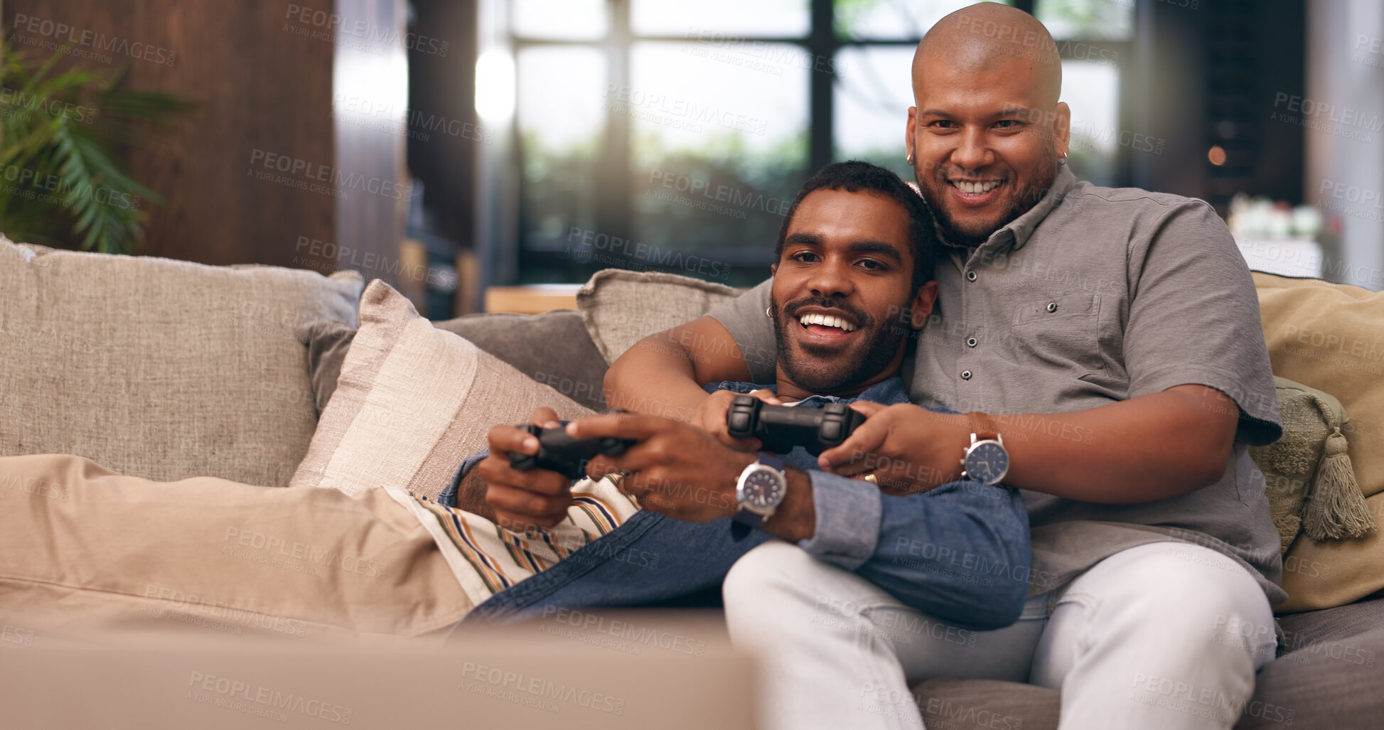 Buy stock photo Home, gay couple and gaming with controller on sofa for multiplayer, competition and entertainment. Lgbtq, queer love and men with smile in living room for esports challenge, streaming and contest